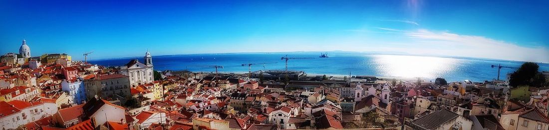 Panoramic view of sea against clear blue sky