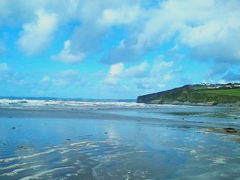 Scenic view of sea against cloudy sky