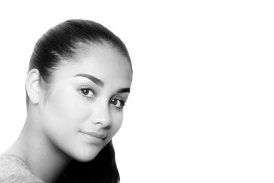 Portrait of young woman against white background