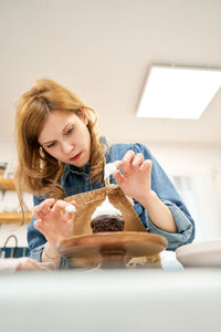 Portrait of a smiling young woman sitting at home