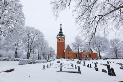 Snow covered trees and a church