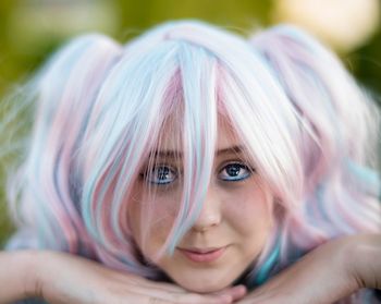 Close-up portrait of woman wearing wig and mascara