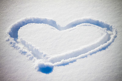 Close-up of heart shape on snow