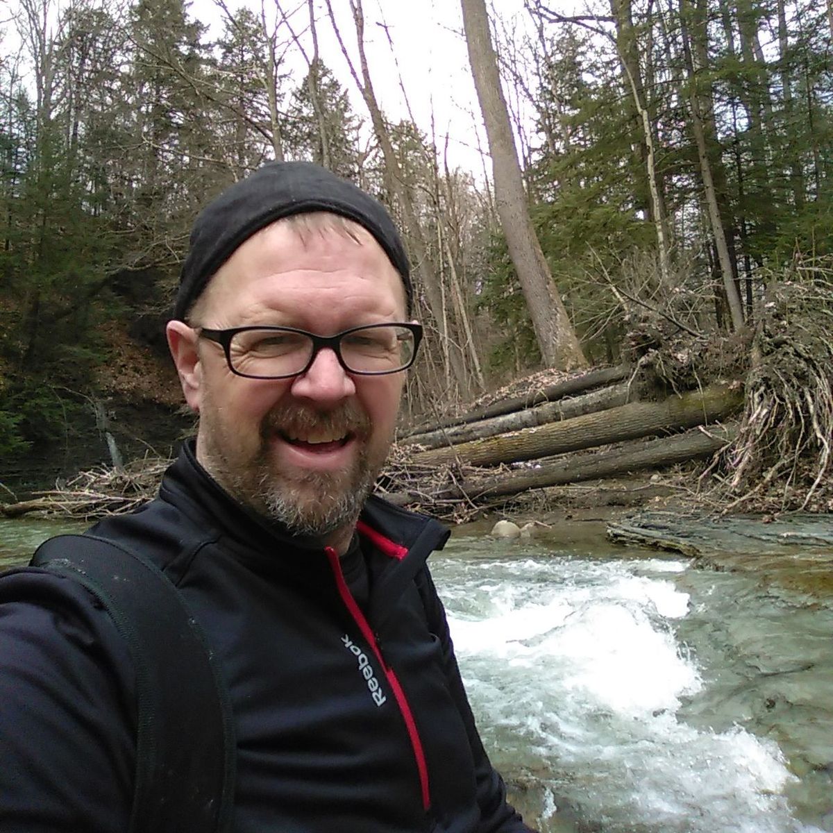 beard, tree, lifestyles, front view, eyeglasses, mid adult men, leisure activity, one person, portrait, happiness, real people, water, nature, day, smiling, outdoors, people, adult