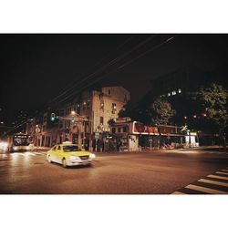 Illuminated city street at night