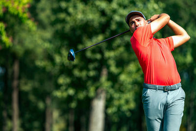 Professional golfer in a swing using a driver golf club