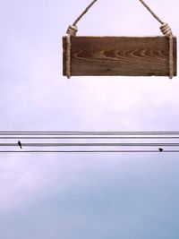 Low angle view of power line against sky