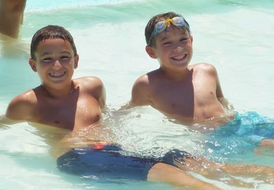 Portrait of smiling boy swimming in pool