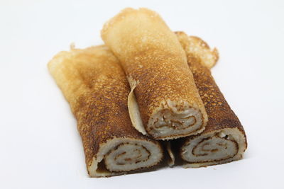 Close-up of bread over white background