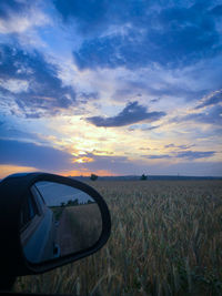 Scenic view of sunset seen through car windshield