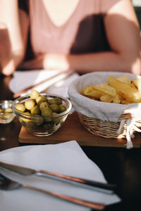 Midsection of man preparing food in plate on table