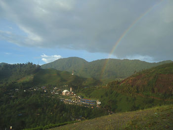 High angle view of rainbow over mountain against sky
