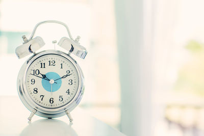 Close-up of clock on table