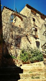 Low angle view of abandoned building against sky