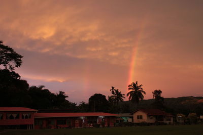 Scenic view of rainbow against sky at sunset