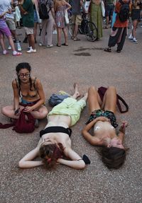 High angle view of friends lying on street