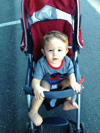 Portrait of boy sitting outdoors