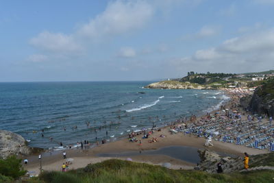 High angle view of people on beach against sky