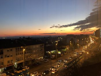 High angle view of illuminated buildings against sky at sunset