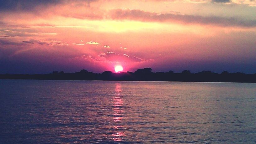 water, sunset, scenics, waterfront, tranquil scene, sky, beauty in nature, tranquility, sun, reflection, idyllic, cloud - sky, nature, rippled, sea, lake, dramatic sky, cloud, silhouette, orange color