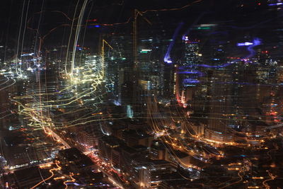 Light trails on illuminated city at night