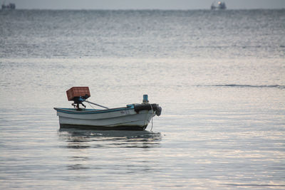 Rear view of man in boat sailing on sea