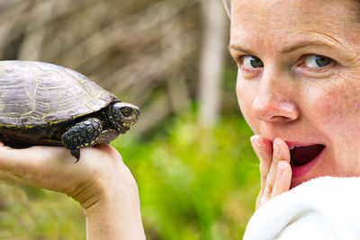 Close-up of man holding turtle