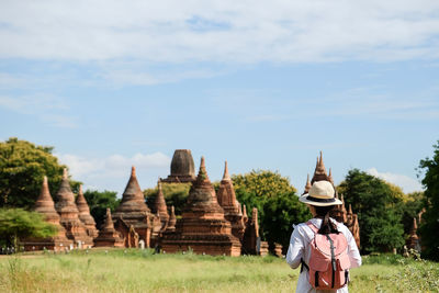 Rear view of woman visiting old historic temple