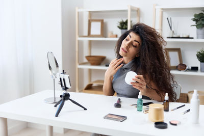 Beautician applying make up at home