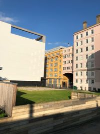 Exterior of buildings in city against clear blue sky