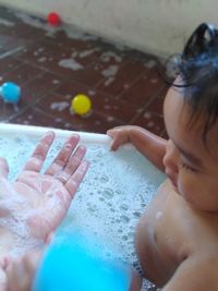 High angle view of baby boy playing in bathroom