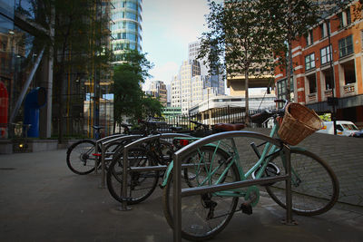 Bicycles on street against buildings in city