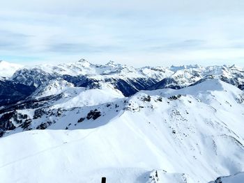 Scenic view of snow mountains against sky