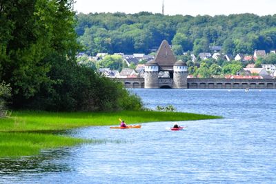 People kayaking in river