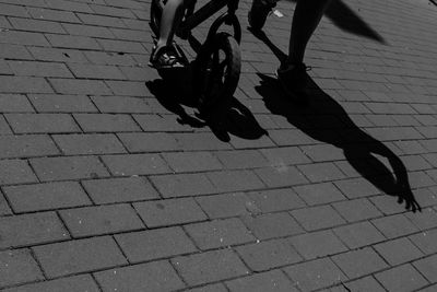 Low section of man walking on zebra crossing