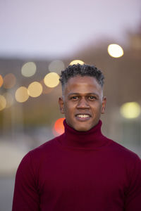 Portrait of young man standing against sky