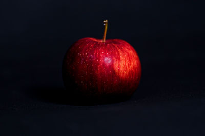 Close-up of apple against black background