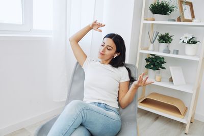 Portrait of young woman sitting at home