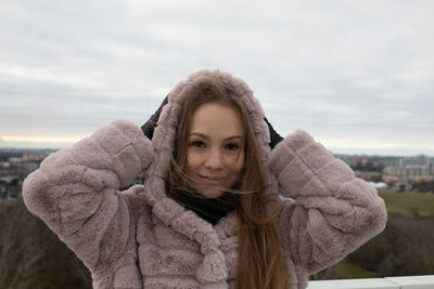 Portrait of woman with ice cream against sky