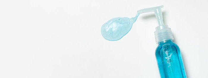 Close-up of blue bottle against white background