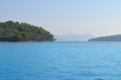 Scenic view of calm sea against clear sky