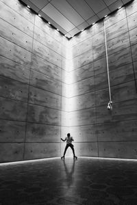 Full length of silhouette man walking in illuminated building