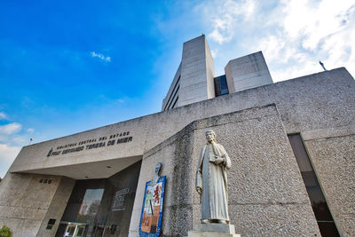 Low angle view of statue against building in city