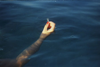 CLOSE-UP OF WOMAN HAND HOLDING WATER