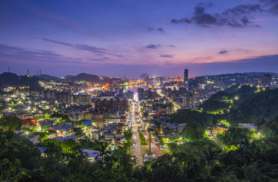 High angle view of illuminated buildings against sky at sunset