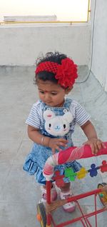 High angle view of baby girl sitting outdoors