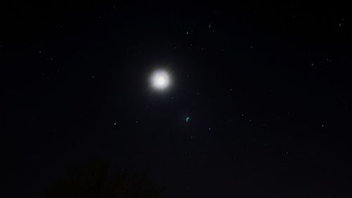 Low angle view of moon against sky at night