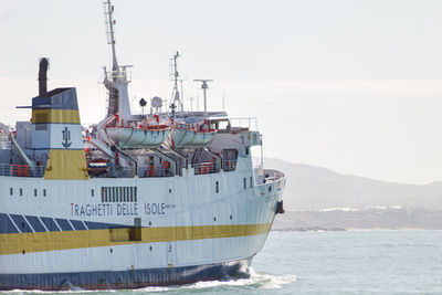 Ship sailing on sea against clear sky