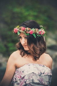 Midsection of woman with pink flower