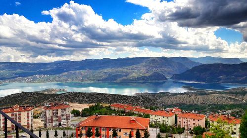 Town by mountains against sky